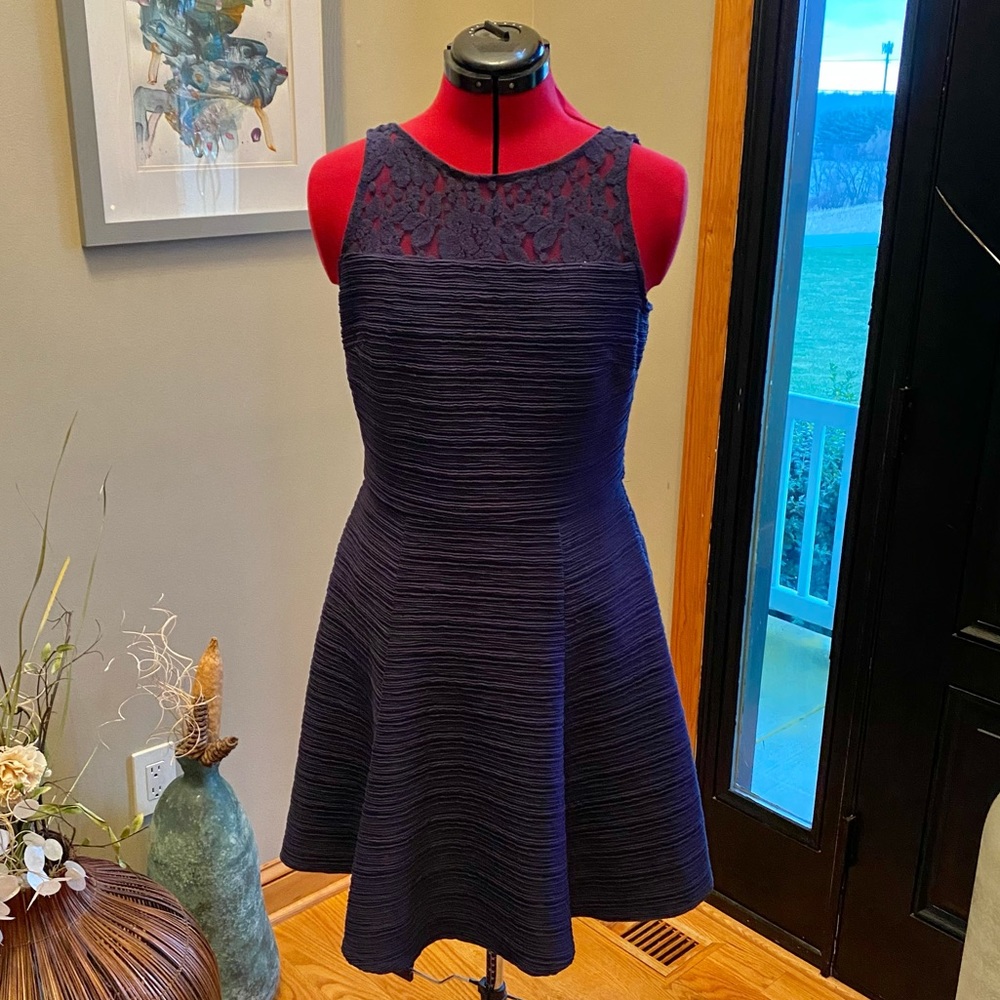 Navy blue dress with lace detail.